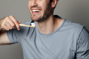 man getting ready to brush his teeth with toothbrush with whitening toothpaste